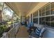 Cozy screened porch with comfortable seating and a lovely view of the yard at 10376 Se 43Rd Ct, Belleview, FL 34420