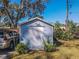 Shot of the storage shed near the carport and landscaping at 10376 Se 43Rd Ct, Belleview, FL 34420