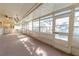 Spacious sunroom with lots of windows and natural light, ceiling fan, and an open layout for a tranquil atmosphere at 10376 Se 43Rd Ct, Belleview, FL 34420
