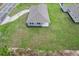Aerial view of the home featuring blue siding and a green lawn at 10512 Sw 49Th Avenue Rd, Ocala, FL 34476