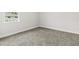 Carpeted room with neutral paint, bright white trim, and a window at 10512 Sw 49Th Avenue Rd, Ocala, FL 34476
