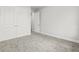 This bedroom features neutral carpet, base molding, and doors leading to a closet and the rest of the home at 10512 Sw 49Th Avenue Rd, Ocala, FL 34476
