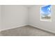 This bedroom features neutral carpet and a window at 10512 Sw 49Th Avenue Rd, Ocala, FL 34476