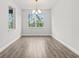 Bright dining room featuring hardwood floors, a chandelier, and natural light from surrounding windows at 10512 Sw 49Th Avenue Rd, Ocala, FL 34476