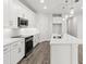 Contemporary kitchen featuring white cabinets, stainless steel appliances, and an island with bar seating at 10512 Sw 49Th Avenue Rd, Ocala, FL 34476
