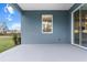 This patio features blue siding and a sliding glass door at 10512 Sw 49Th Avenue Rd, Ocala, FL 34476