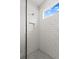 This bathroom has a spacious, tiled shower with a built-in niche and modern fixtures at 10512 Sw 49Th Avenue Rd, Ocala, FL 34476