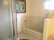 Bright bathroom featuring a bathtub with tiled surround and a glass-enclosed shower, plus neutral decor at 11552 Sw 138Th Ln, Dunnellon, FL 34432