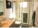 Bathroom features a walk-in shower with glass doors and a well-lit vanity area at 11552 Sw 138Th Ln, Dunnellon, FL 34432