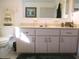 Bright bathroom features a classic vanity with ample storage space and neutral-toned tile at 11552 Sw 138Th Ln, Dunnellon, FL 34432