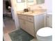 Bathroom vanity with a neutral countertop and a toilet, offering a functional space at 11552 Sw 138Th Ln, Dunnellon, FL 34432