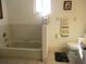 Bright bathroom featuring a tub, toilet, and window for natural light at 11552 Sw 138Th Ln, Dunnellon, FL 34432