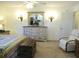 Cozy bedroom features a decorative dresser with a vintage mirror and a comfortable recliner at 11552 Sw 138Th Ln, Dunnellon, FL 34432
