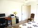 Bedroom with a desk, chair, and a lamp next to the bed at 11552 Sw 138Th Ln, Dunnellon, FL 34432