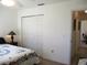 Bright bedroom with a closet, patterned quilt, and view to another room at 11552 Sw 138Th Ln, Dunnellon, FL 34432