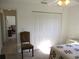 Bedroom with a closet and a chair next to the bed at 11552 Sw 138Th Ln, Dunnellon, FL 34432