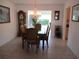 Formal dining area with tile flooring, elegant chandelier, and classic furnishings at 11552 Sw 138Th Ln, Dunnellon, FL 34432