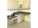 Kitchen desk area with light-colored cabinetry, drawers, and tile flooring at 11552 Sw 138Th Ln, Dunnellon, FL 34432
