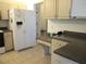 Spacious kitchen featuring tile flooring, white appliances, and light-colored cabinetry at 11552 Sw 138Th Ln, Dunnellon, FL 34432