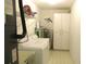Functional laundry room with modern washer, dryer, cabinets, and shelving for organized storage at 11552 Sw 138Th Ln, Dunnellon, FL 34432