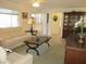 Comfortable living room with view to the china cabinet and partial view of bathroom at 11552 Sw 138Th Ln, Dunnellon, FL 34432