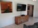 Stylish living room features built-in cabinet, a large television, and open access to other rooms at 11552 Sw 138Th Ln, Dunnellon, FL 34432