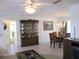 Open-concept living room view to the dining table and partial bathroom at 11552 Sw 138Th Ln, Dunnellon, FL 34432