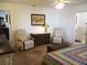 Cozy main bedroom with quilted bedspread, dressers, and adjacent bathroom access at 11552 Sw 138Th Ln, Dunnellon, FL 34432