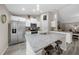 Kitchen island with granite countertop and seating plus stainless steel refrigerator at 13281 Sw 71St Ln, Ocala, FL 34481