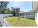 Spacious backyard with pool enclosure and white picket fence at 13677 Sw 40Th Avenue Rd, Ocala, FL 34473