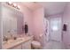The pink bathroom features a coordinated vanity, toilet, and shower/tub combination at 13677 Sw 40Th Avenue Rd, Ocala, FL 34473
