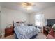 This cozy bedroom has a large window, wood furniture, and carpet flooring at 13677 Sw 40Th Avenue Rd, Ocala, FL 34473