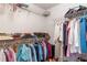 Walk-in closet with shelving for folded clothing, accessories, and hanging apparel at 13677 Sw 40Th Avenue Rd, Ocala, FL 34473
