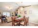 Open-concept dining area featuring a wood table, elegant lighting and seamless access to the living room at 13677 Sw 40Th Avenue Rd, Ocala, FL 34473