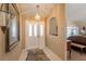 Inviting entryway features tiled floor, neutral walls, chandelier lighting, and arched doorway at 13677 Sw 40Th Avenue Rd, Ocala, FL 34473
