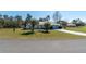 Charming home with an expansive yard, long driveway, mature palm trees, and neatly trimmed lawns at 13677 Sw 40Th Avenue Rd, Ocala, FL 34473