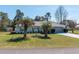 Attractive home with a well-kept lawn, mature landscaping, and an extended driveway at 13677 Sw 40Th Avenue Rd, Ocala, FL 34473