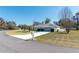 Well-maintained home with a spacious front yard and driveway, complemented by green lawns at 13677 Sw 40Th Avenue Rd, Ocala, FL 34473