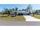 Single-story home featuring lush green lawn and mature landscaping with easy driveway access to a two car garage at 13677 Sw 40Th Avenue Rd, Ocala, FL 34473