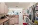 Well-lit kitchen featuring stainless steel appliances, an eat-in area, and stylish countertops at 13677 Sw 40Th Avenue Rd, Ocala, FL 34473