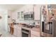 Well-equipped kitchen with stainless steel appliances, a built-in cooktop, and ample countertop space at 13677 Sw 40Th Avenue Rd, Ocala, FL 34473