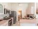 Well-lit kitchen features stainless steel appliances, a ceiling fan, and views into the front entryway at 13677 Sw 40Th Avenue Rd, Ocala, FL 34473