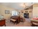 Cozy living room with a vaulted ceiling, carpet, and a ceiling fan with a chandelier at 13677 Sw 40Th Avenue Rd, Ocala, FL 34473