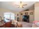 Cozy living room with a vaulted ceiling, carpet, and a ceiling fan with a chandelier at 13677 Sw 40Th Avenue Rd, Ocala, FL 34473