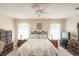 The main bedroom features a ceiling fan, natural light, and a wooden furniture set at 13677 Sw 40Th Avenue Rd, Ocala, FL 34473