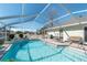 Inviting screened pool and patio offers a perfect spot for relaxation and outdoor entertainment at 13677 Sw 40Th Avenue Rd, Ocala, FL 34473