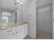 Elegant bathroom with granite countertops, a vanity, and a walk-in closet at 17799 Se 125Th Cir, Summerfield, FL 34491