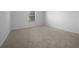 Bedroom featuring neutral carpeting, a window and base molding around the perimeter at 17799 Se 125Th Cir, Summerfield, FL 34491