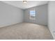 Bedroom featuring neutral carpeting, white walls and a window with natural light at 17799 Se 125Th Cir, Summerfield, FL 34491