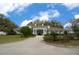 Inviting community clubhouse with a welcoming entrance, lush landscaping, and classic architectural details at 17799 Se 125Th Cir, Summerfield, FL 34491